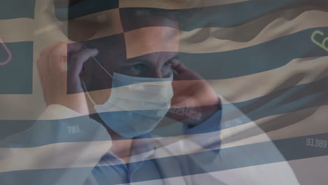 animation of numbers and greece flag over caucasian male doctor in face mask