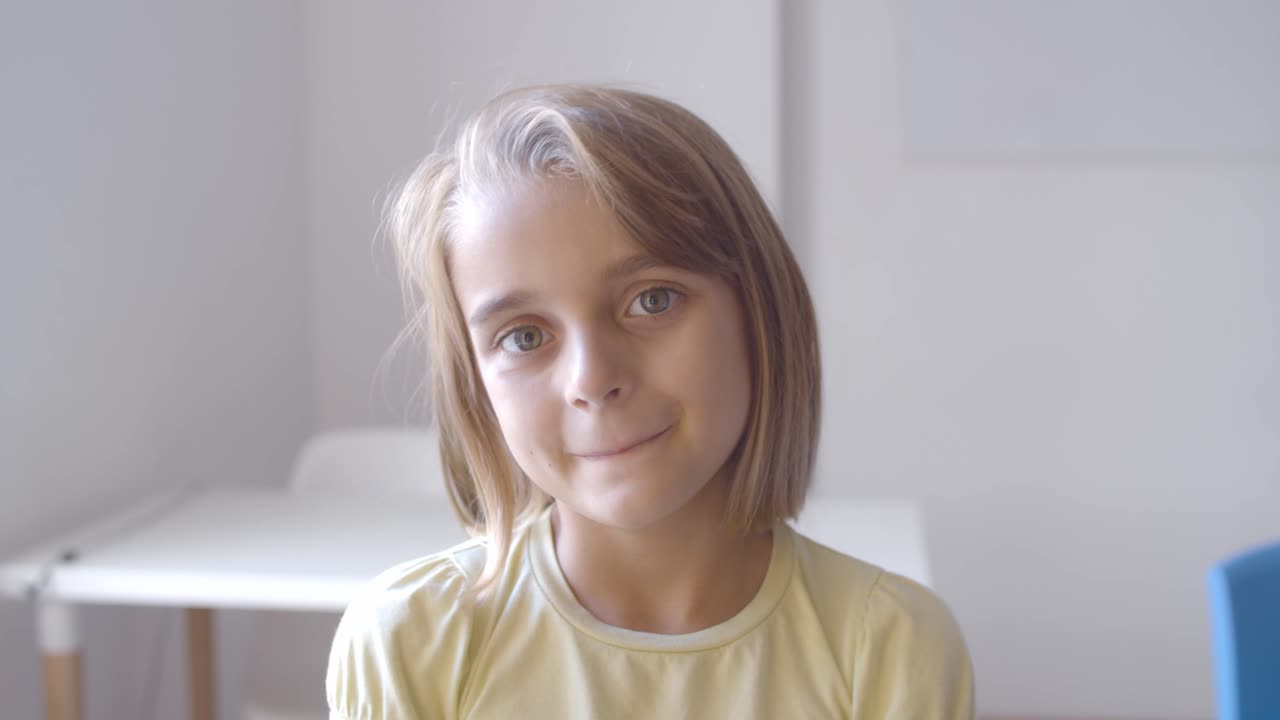 chica caucásica muy positiva de pie en el salón de clases