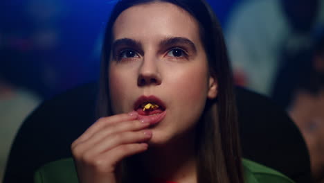 focused woman watching film in cinema