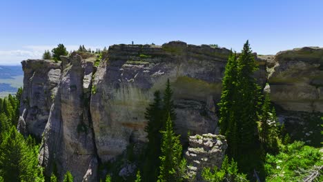 Aerial-view-of-an-interesting-rock-formation-with-green-vegetation-and-trees-around-it