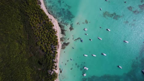 Aerial-view-above-yachts-on-the-coastline-of-Punta-Cana,-golden-hour-in-Dominican-republic---top-down,-drone-shot