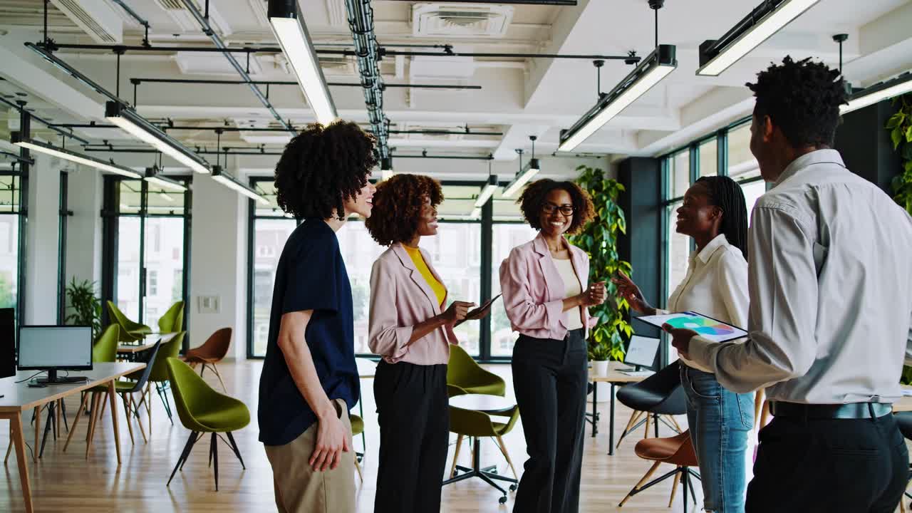 Video captures a diverse team in a modern office, discussing with enthusiasm