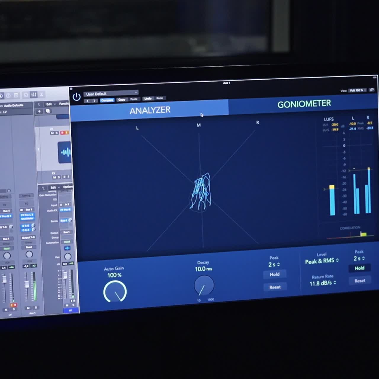 Screen switched on in the dark room for music recording. Equipment for professional music procession and creation
