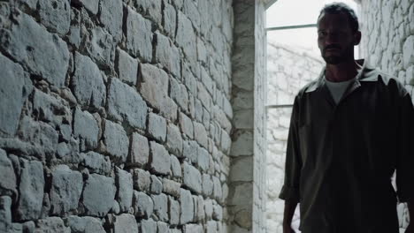 prisoner in a stone corridor