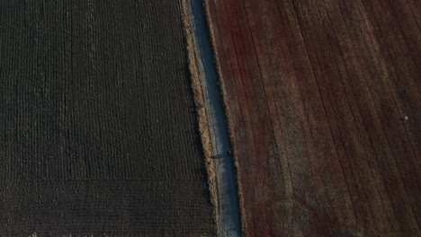 aerial shot moving away from great height focusing on a walking monk