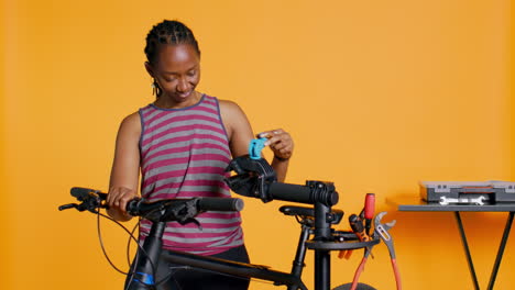 engineer setting up bike repair stand, using it to adjust derailleur