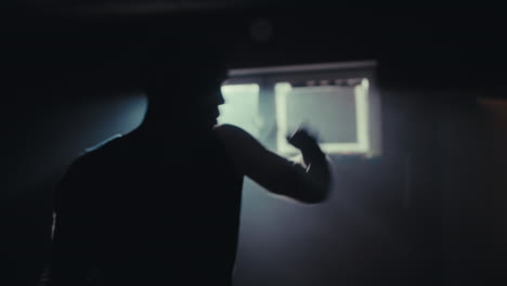 man boxing in a dark room