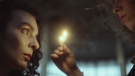 two people sharing a moment with a lit match