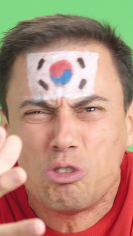 man with south korean national flag upset with a referee