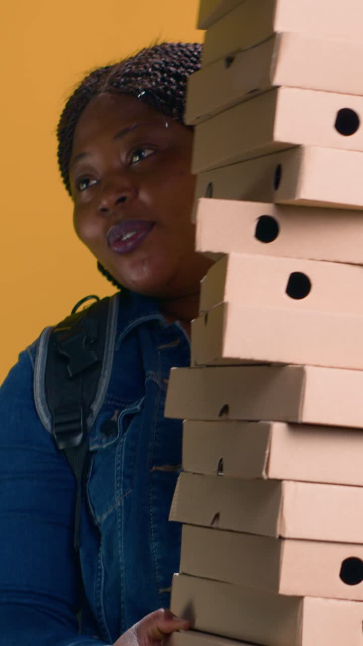 Wanita dengan setumpuk kotak pizza