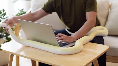 Man-working-with-snake-at-home