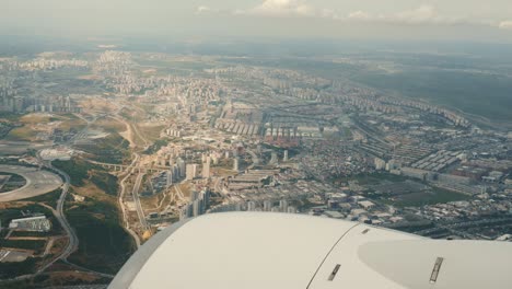 amazing aerial view of istanbul city from airplane window during flight, beautiful sunny urban panorama and plane engine