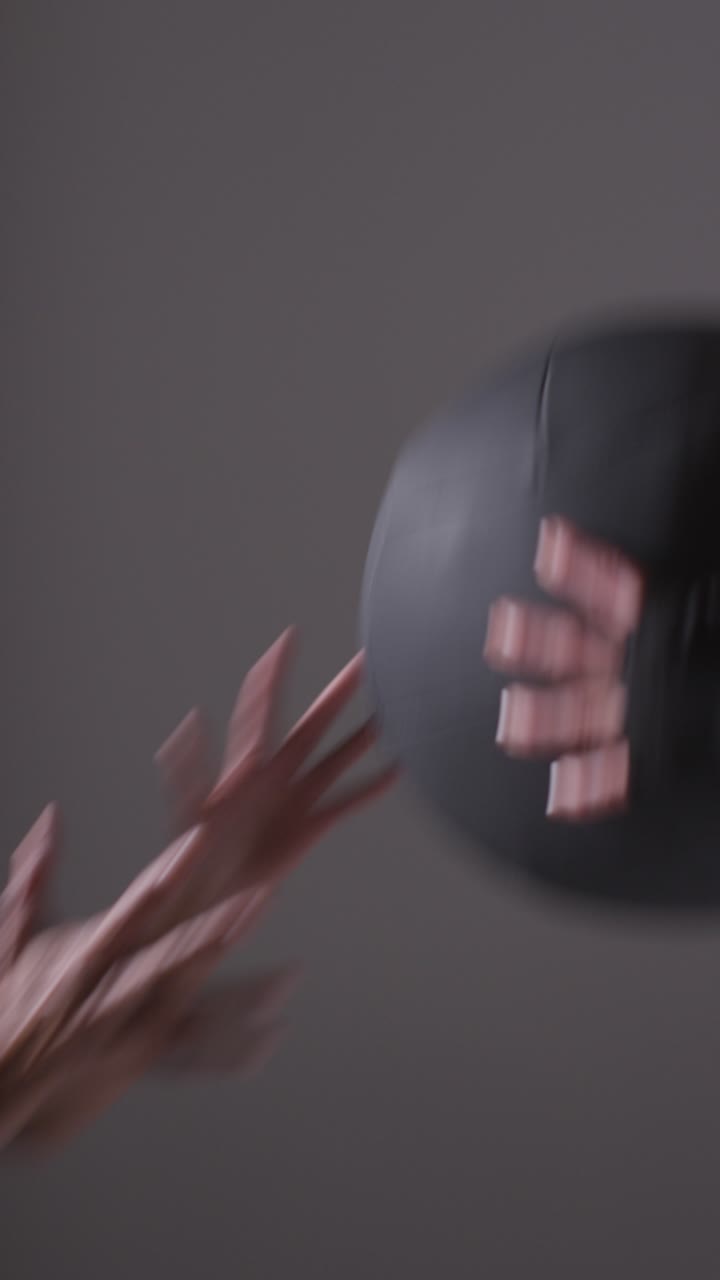 Vertical Video Studio Shot Of Two Mature Women Wearing Gym Fitness Clothing Training With Weighted Medicine Ball Together