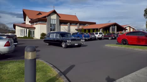 Shot-of-hearse-arriving-or-leaving-a-funeral