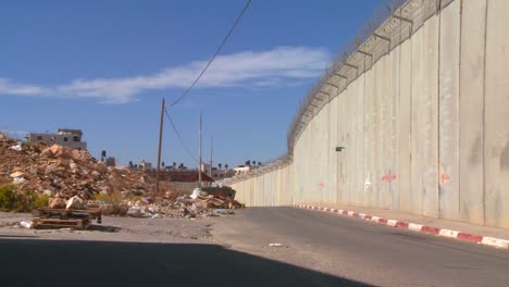 trash and garbage collect along the base of the new west bank barrier between israel and the palestinian territories 1