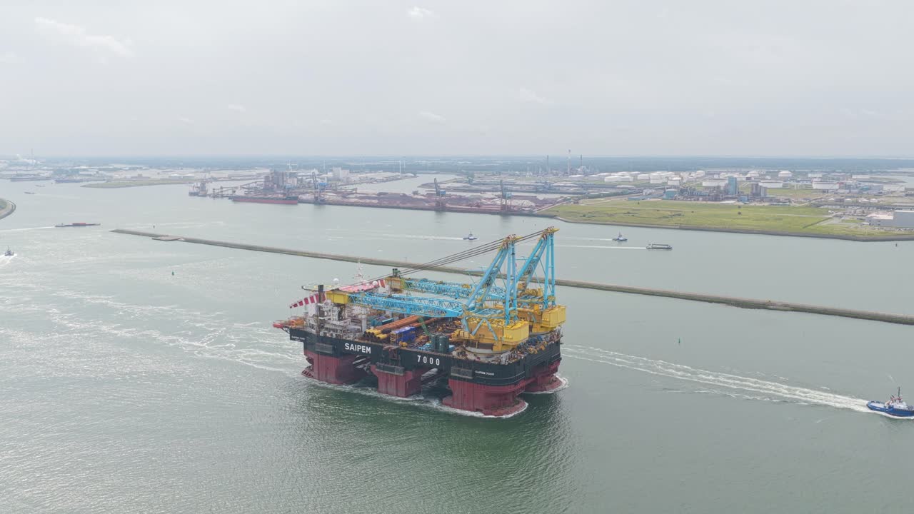 Pipelay crane vessel cruising Rotterdam harbor at daytime, Netherlands