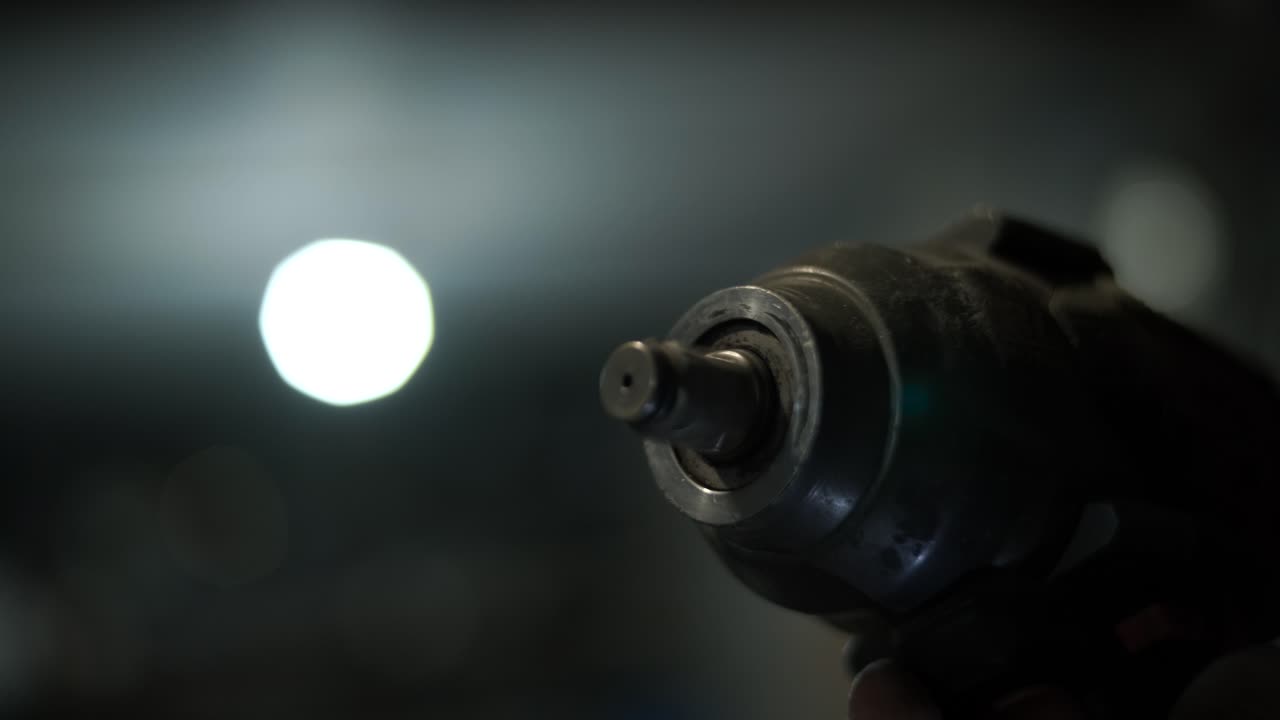 Close-up of an Impact Wrench Operating in a Dark Setting