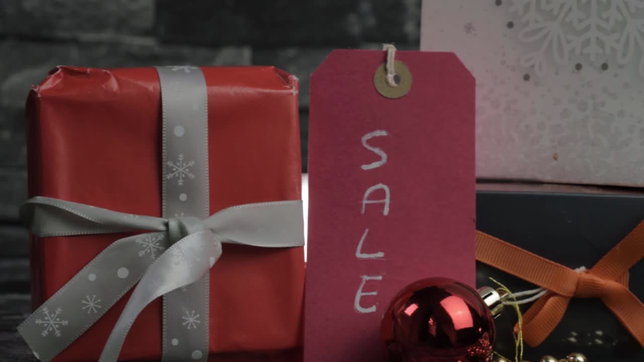 Display of Christmas gifts and decorations in a sale medium panning shot