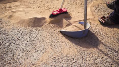 high fps, sweeping sand from pavement in an arid dry surface during a hot summer sunny day in spain