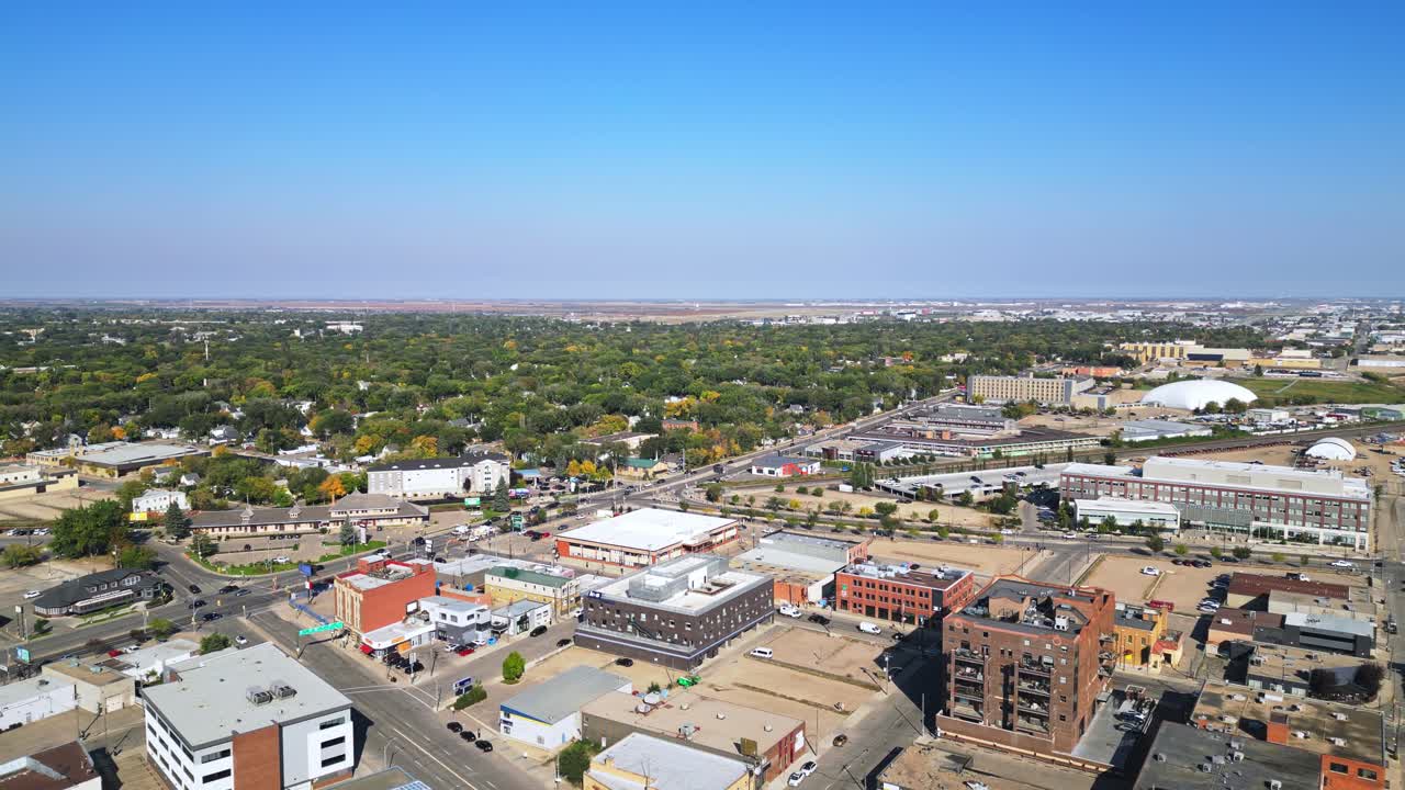 Slow aerial pan of Saskatoon in fall, deep blue sky, older district, parks