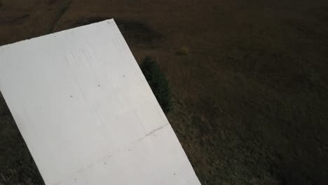 Drone-flying-over-national-resistance-monument,-Plateau-des-Glières-in-Haute-Savoie,-France