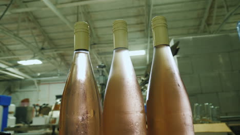 wine bottles closed with a cork stopper move along the conveyor belt view from above