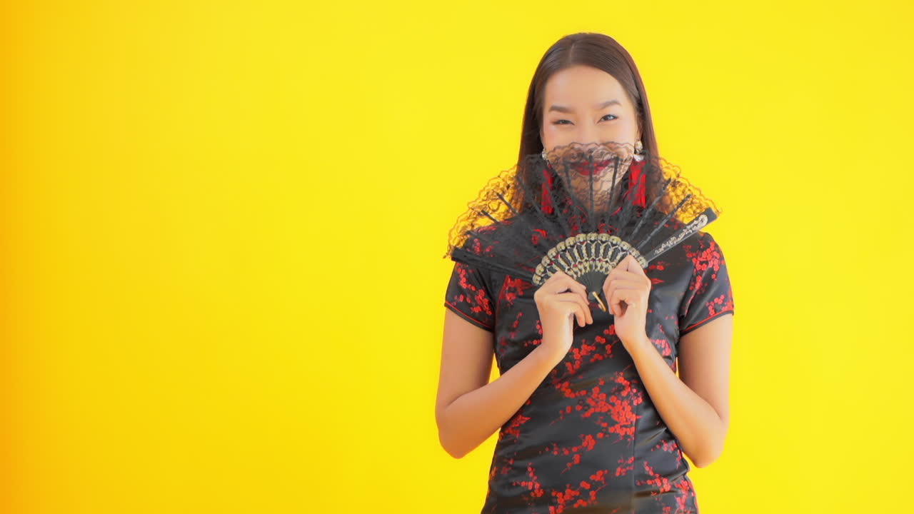 Chinese girl traditional attire posing with handmade fan