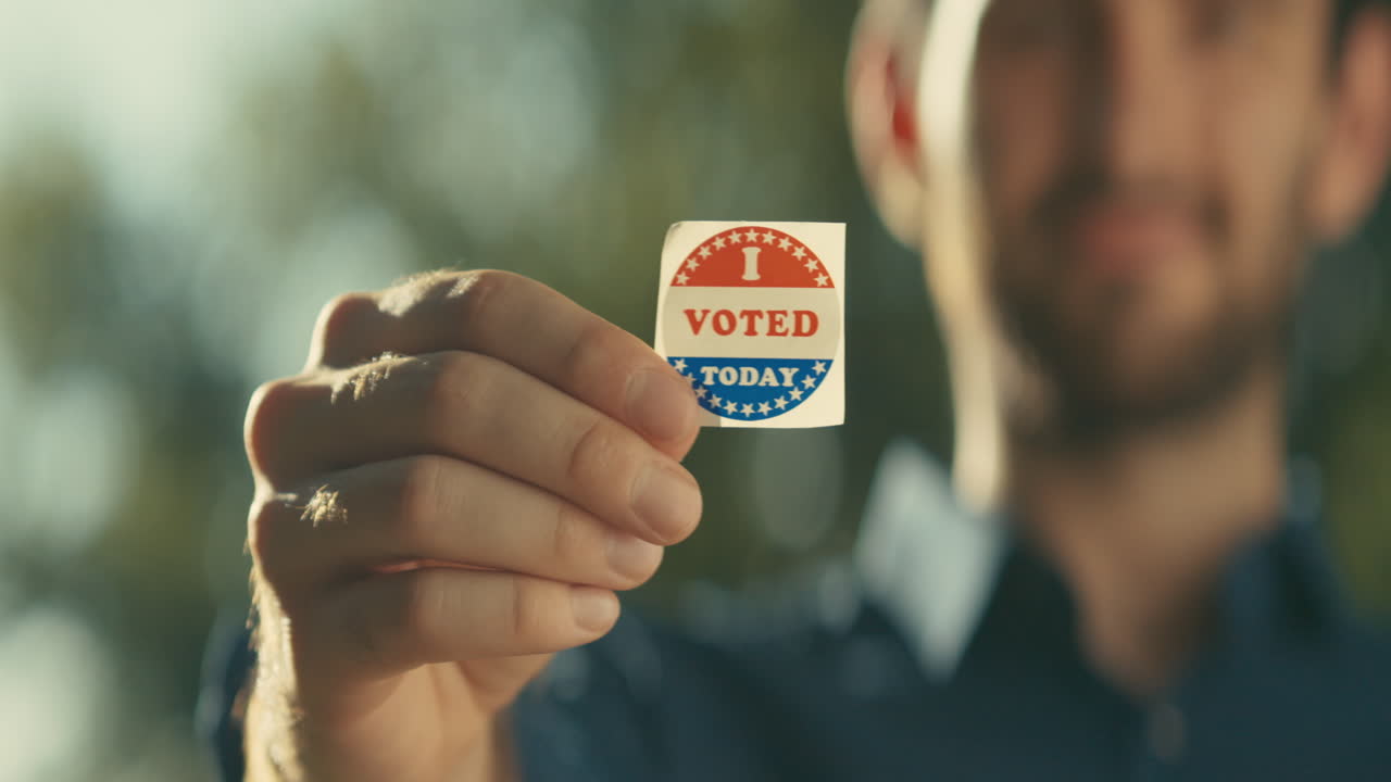 Man holding a vote sticker