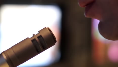 person singing into a microphone