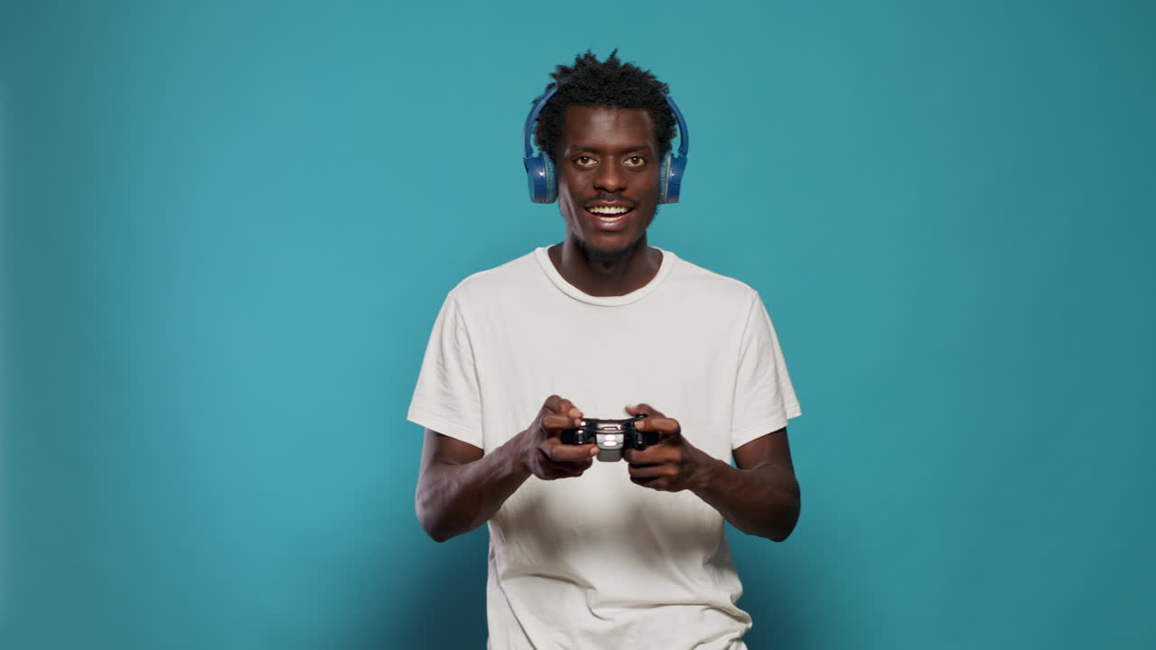 African american gamer playing video games with controller