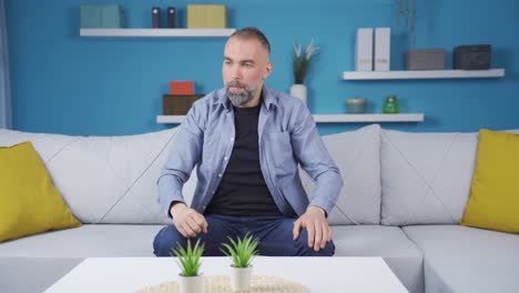 Angry-man-banging-his-head-on-the-table.