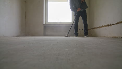 Static-wide-shot-of-sweeping-the-floor-in-an-empty-room