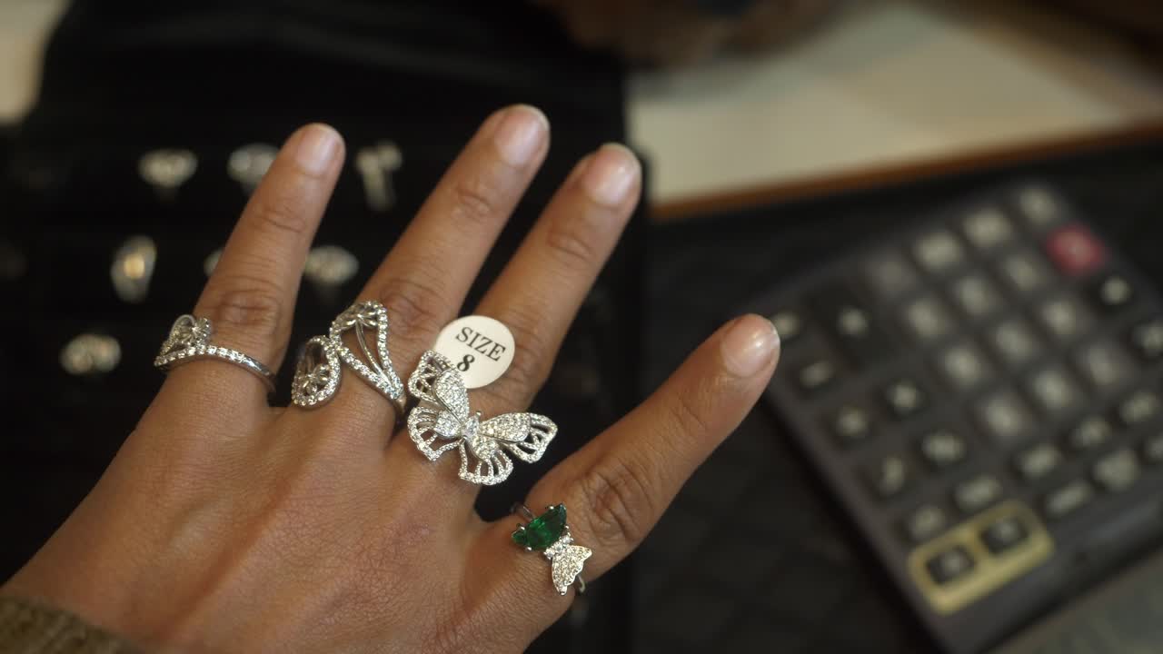 Closeup of designer and trendy silver finger rings studded with lab grown diamonds