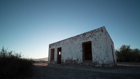 abandoned stone building in the desert at sunrise/sunset