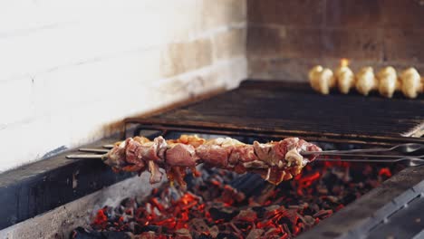 cooking delicious meat on charcoal. meat on skewers. marinated shashlik preparing on a barbecue grill. appetizing meat grilled on skewers.