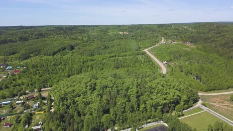 aerial view of a rural landscape with road and forest