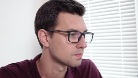 closeup view of concentrated young businessman in glasses working at the office. shot in 4k