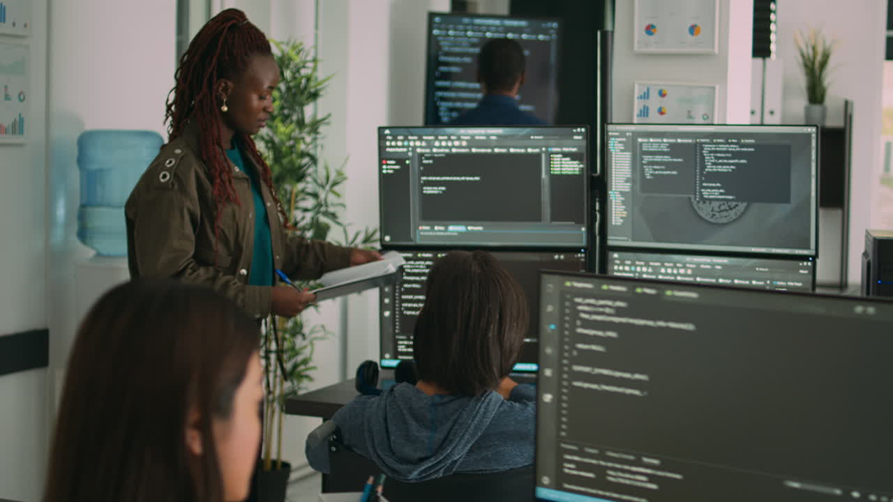 Asian coder with physical disability working with african american developer