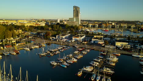 gdynia city port panoramic view - modern sea towers and skyscrapers with sailboats and yachts docked at the baltic coast of poland