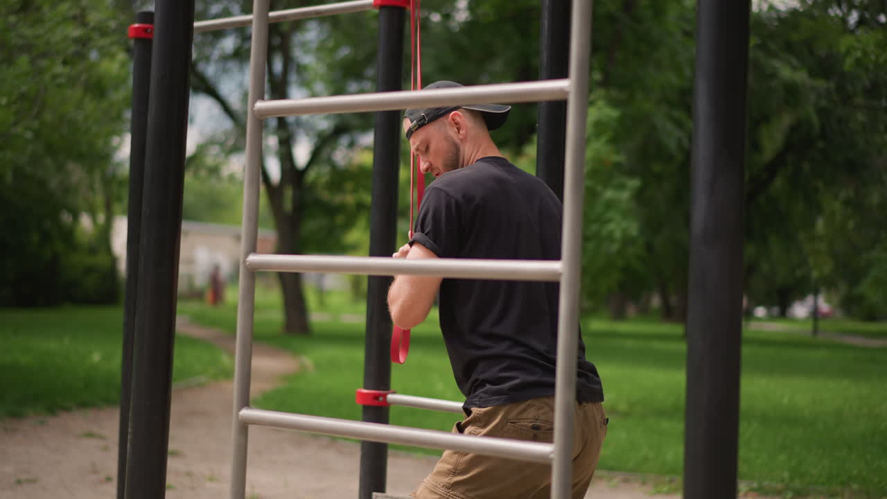 Man Inspects Outdoor Equipment, Male Checks And Adjusts Outdoor Fitness Stations Before Exercise Session, Man Carefully Inspects And Aligns Exercise Equipment Within Peaceful Park Environment