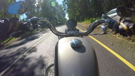 Riding-a-motorcycle.-Biker-rides-on-the-road-with-a-first-person.