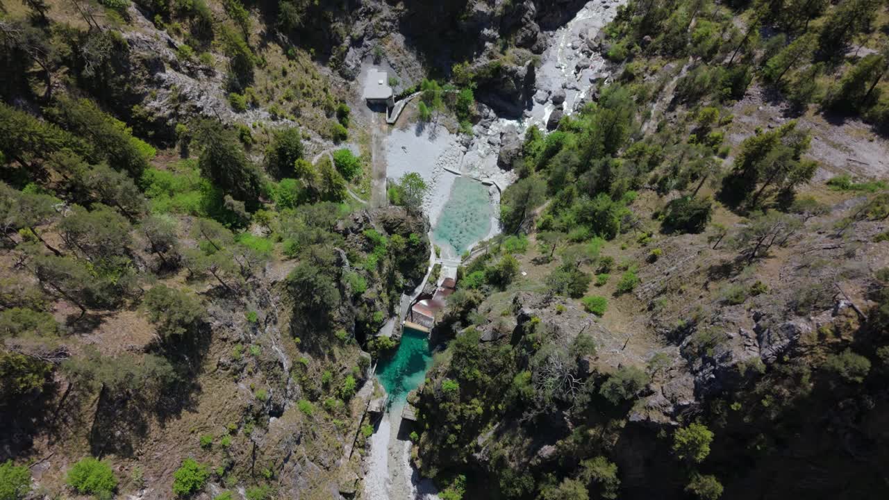bird view drone hidden lake in the mountains with woman swimming