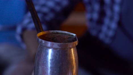 a hand places the pot with the coffee on the fire