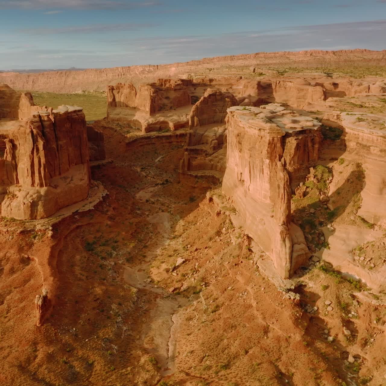 Curved rocks of amazing canyons in Utah, United States. Drone footage over the mountains and deserted land on sunny day