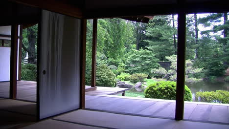 pan from interior of japanese house to view of garden and koi pond