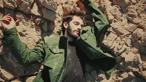 top down view of lifeless israeli man lying on dry rocky desert terrain