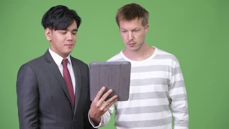 young handsome asian businessman and young scandinavian businessman working together