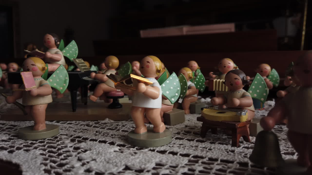 Medium close panning shot of a Hummel figurine orchestra