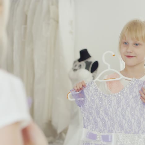 funny girl 6 years old trying on a new dress