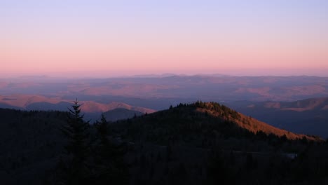 a stunning sunset colors the mountains creating a serene scene a stunning sunset casts vibrant colors over majestic mountains silhouetted against the sky they stand tall with trees adding natures beauty